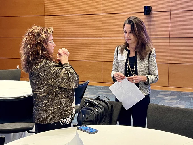 CTSI's Julie Eckstrand talking with Dr. Svati Shah during the Genomics Scientific Retreat. 