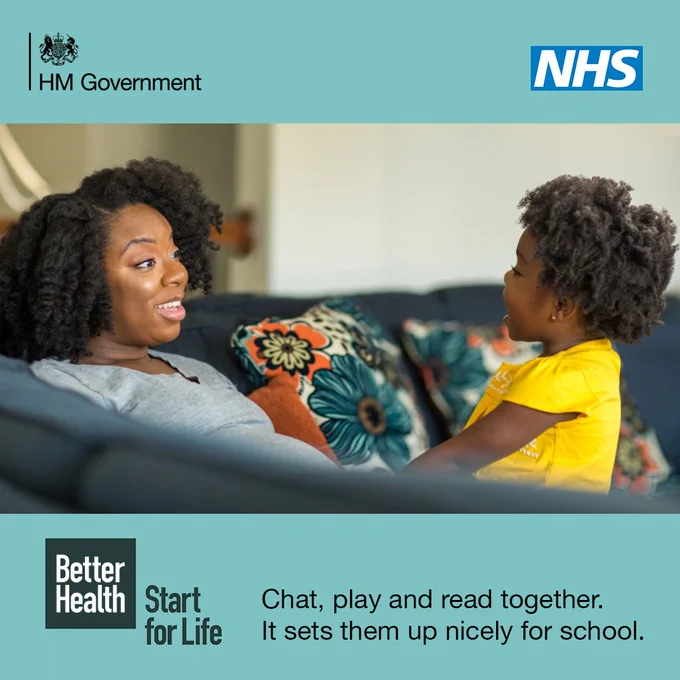 "Image shows a parent chatting with their young child on the sofa. 

The logo top left reads: HM Government.

The NHS logo is present top left. 

The text below reads: Chat, play, read together. It sets them up nicely for school. 

The logo bottom right reads: Better Health, Start for Life. "
