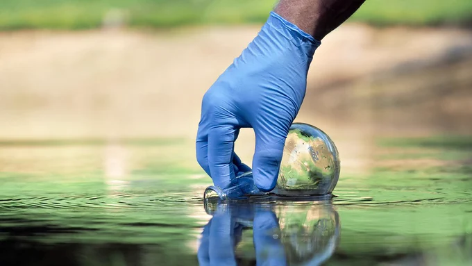 A water sample being collected by someone