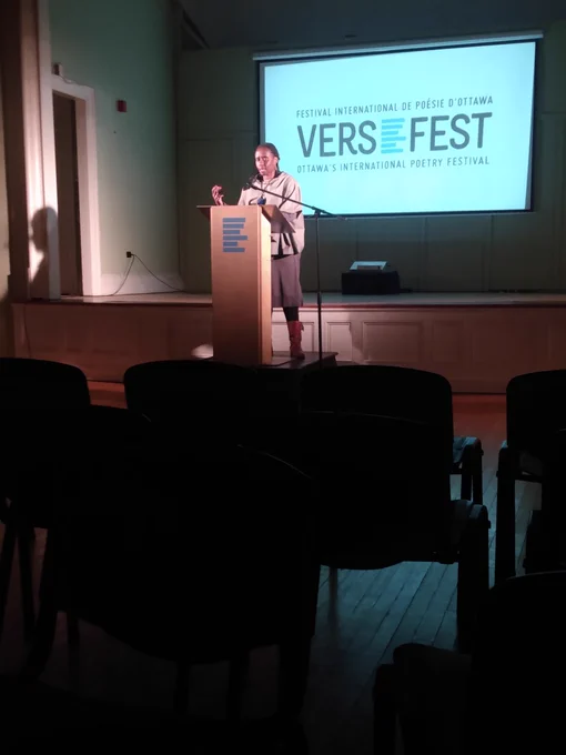 Juliane Okot Bitek reading at the podium.