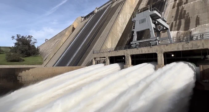 Image of a concrete dam (Friant Dam) releasing water.