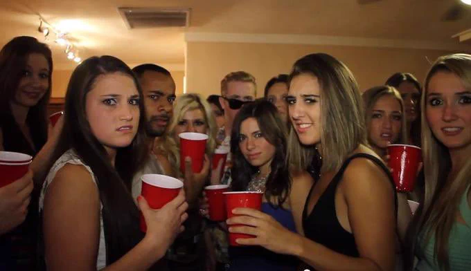 a group of young adults with red solo cups look at you in disgust