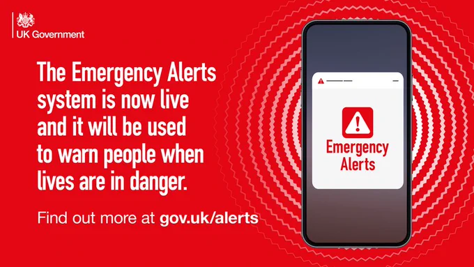 Logo: UK Government. Image of a mobile phone with a warning sign, and the wording Emergency Alerts. Text reads The Emergency Alerts system is now live and it will be used to warn people when lives are in danger. Find out more at gov.uk/alerts