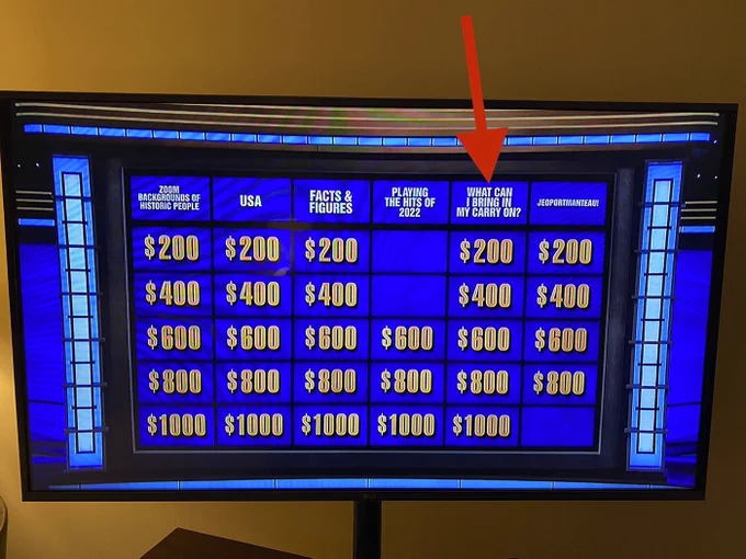 Jeopardy screenshot with an arrow pointing to the category for What Can I Bring in My Carry On?