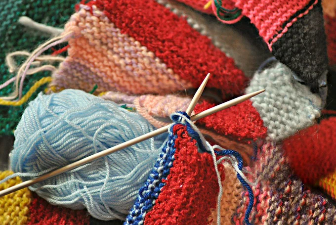 yarn, knitting needles, and knitted fabric in multiple colors