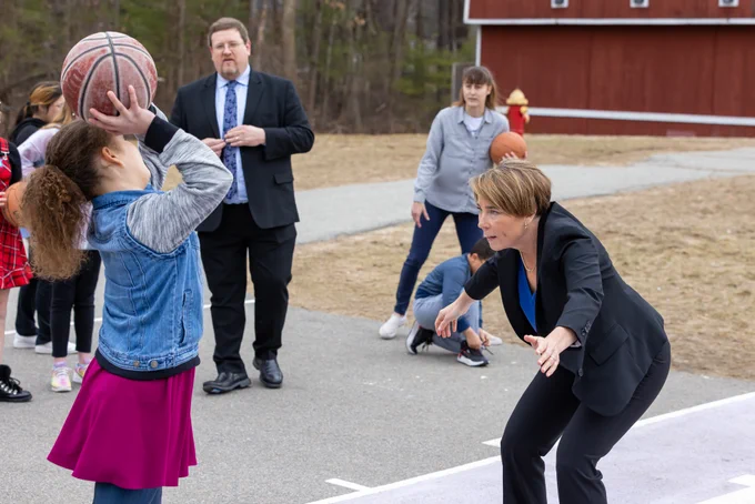 Governor Healey plays basketball with Hajjar Elementary students at recess. 