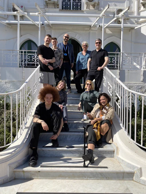 Billy Read, Ben Randall, Hamza Koudri, HMA Sharon Wardle, Rachael Veazey, Cat Sheridan, Kameel Myrie and Wahiba Ghanem on the steps from the Residence to the garden