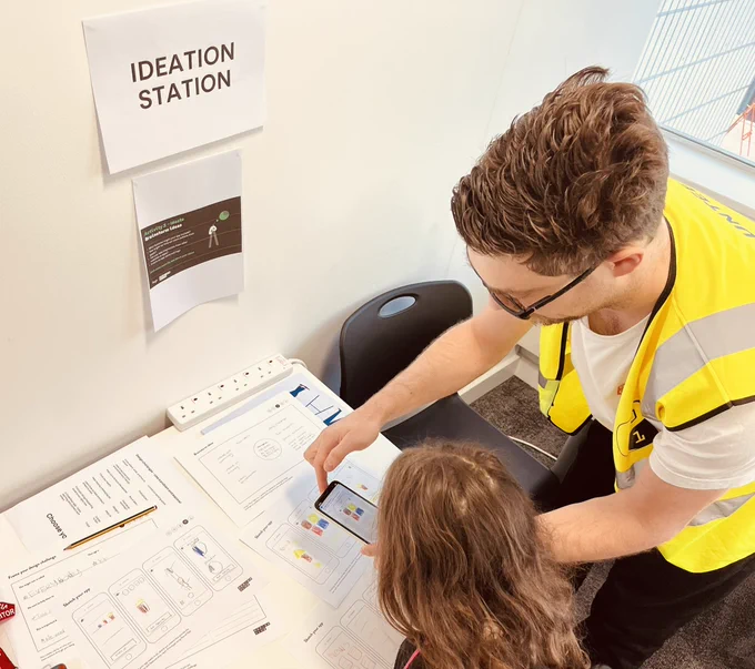 Volunteer James helping a student prototype their mobile app using Marvel.