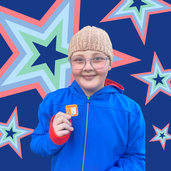 A dark blue background covered in stars. The stars have stripes of coral, blue, light blue, green and dark blue. In the foreground is Abbie - a young girl wearing glasses, a woolly hat and a Guide uniform. She's holding a woven patch with the word 'campaigning' on it.