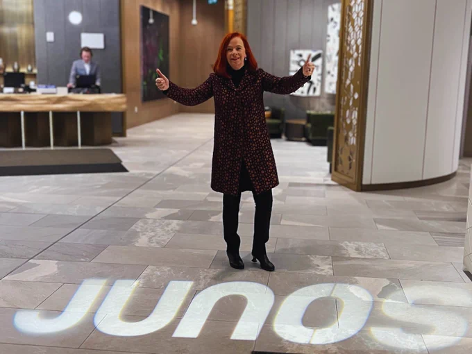 Catherine Tait standing in a hallway with the JUNOS lit up on the ground