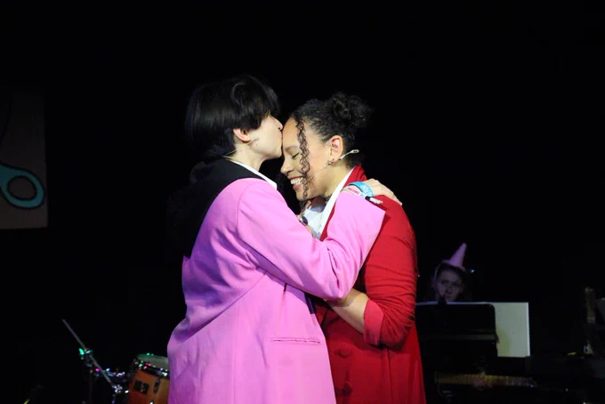 Actor Ashley kisses Jocasta on the forehead.