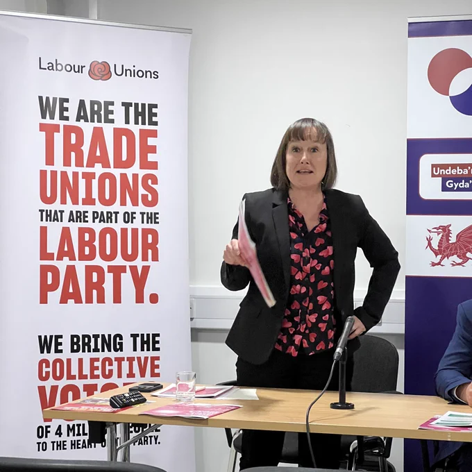 Jo Stevens speaking next to a banner that says we are the trade unions that are part of the Labour Party
