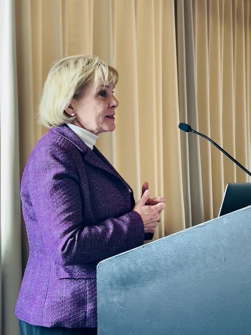 Mary Requa at the podium speaking at SPAN.