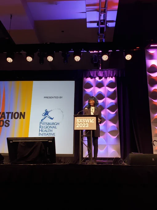Sabaah Folayan receives the SXSW Community Service Award on stage at SXSW.