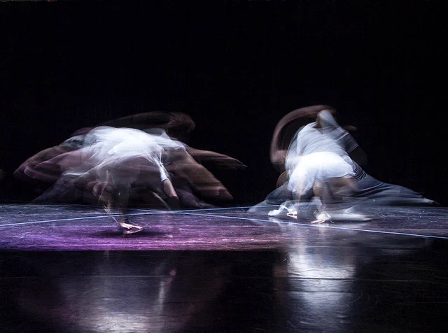 Rose Until it Touched the Sky, credit Alethia Will Edd. Two dancers twirl on stage creating blurred light