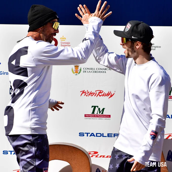Image of Para Snowboarders Kieth Gabel and Noah Elliott doing a handshake on the podium