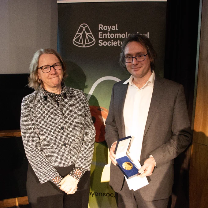 Dr Edgar Turner holding the President Medal from Professor Jane Hill, current President of RES