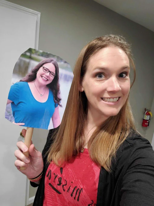 Jen P holding the image of my headshot on a stick - for the "professional" conference selfies (lol)