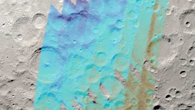 A visualization of the Moon with the region of SOFIA’s lunar water observations indicated in blue. The visualization of SOFIA data of a “light signature” of water overlaid on a visualization of the Moon as it appeared at the time of the observations in Feb. 2022. Darker blue indicates a higher concentration of water. Near the top left of the studied region, a “wet ridge” is visible in dark blue, where the water is particularly concentrated on the shady side of a steep lunar feature. Halfway down the left side of the region is Moretus Crater. The inner wall on the crater’s upper half is clearly delineated in dark blue, indicating a greater presence of water on this shady surface. Although the right side of the region is drier overall, water can still be seen tracing the insides of craters in light blue.
