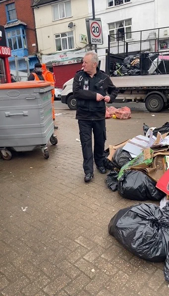 photo of Neighbourhood Enforcement officer at scene of flytip