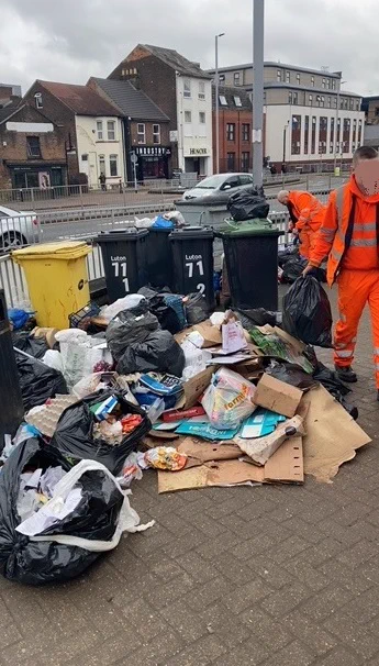 Photo of flytipping response crew searching through waste looking for evidence and removing the waste