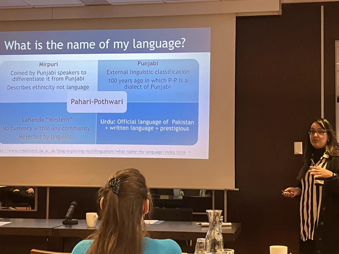 Farah next to a PowerPoint slide titled “What is the name of my language?”