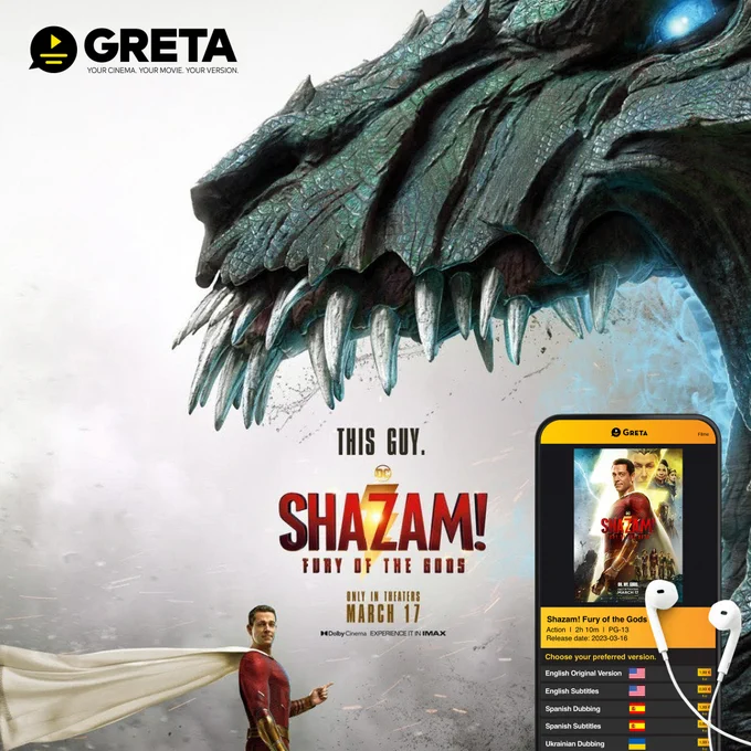 Ein riesiger Drache mit aufgerissenem Mund und spitzen Zähnen. Vor im steht ganz entspannt ein Mann in rotem Anzug und mit Umhang. Daneben ein Smartphone mit der App Greta und verschiedenen Versionen des Films Shazam!