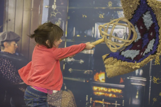 Child beating a rug at Beamish Museum, part of The Forge Northern Writes school's programme exploring mining heritage