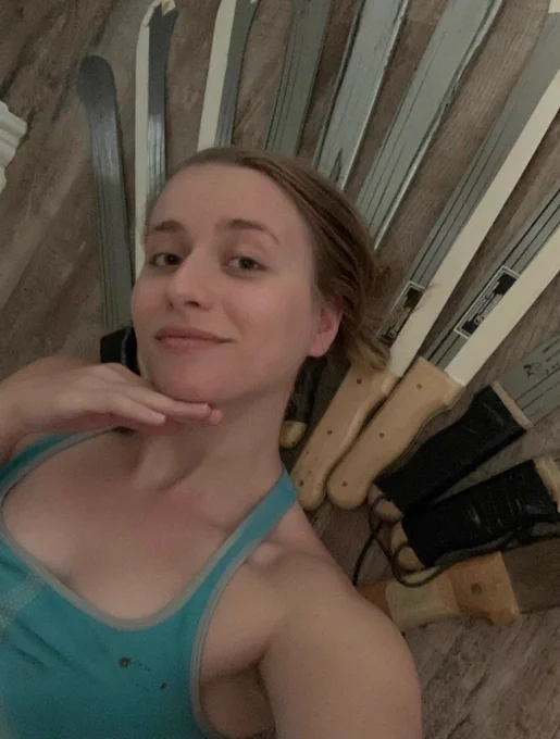 Alanis lying on the ground with 11 machetes organized in a starburst crown shape behind her head.