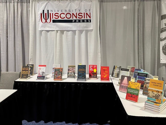 An L-shaped table in the UW Press booth at AAS 2023 in Boston, with many of our recently published books