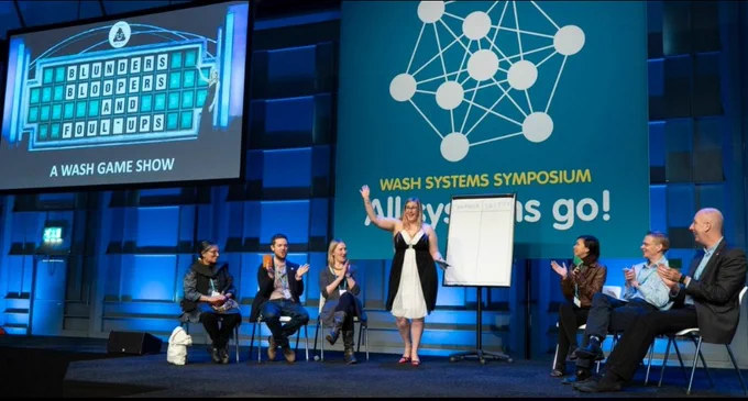 Dani presenting "Blunders, Bloopers and Foul-Ups: A WASH Game Show" at the WASH Systems Symposium.