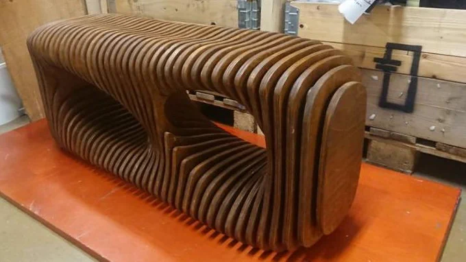 A bench built from CNC cut shapes of plywood.