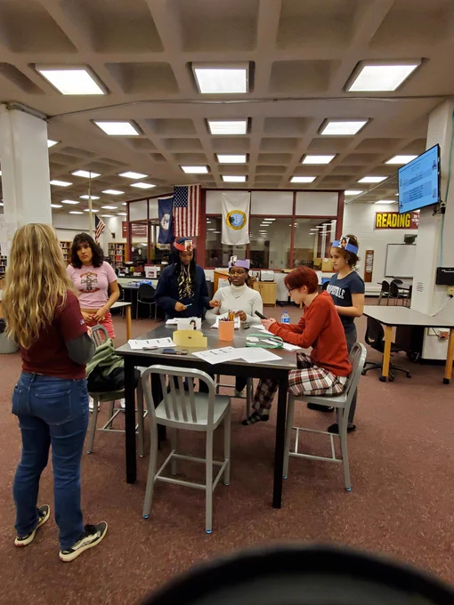 Students listening to Ms. N explain the rules to the game