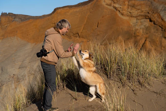 Ben Moon and his dog high-fiving.