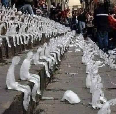 Sculpture of many hundreds of small ice people, some melting.  Powerfully image.
