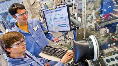 Two male scientists work a computer station at one of the Department of Energy Office of Science National Laboratories. They are working as part of the Graduate Student Research Program which helps to advance the graduate students’ overall doctoral thesis while providing access to the expertise, resources, and capabilities available at the DOE laboratories/facilities.