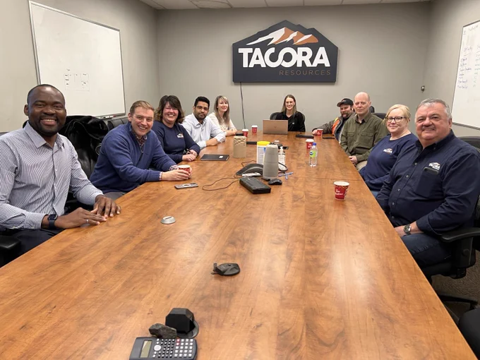 Premier with a group of Tacora employees sat at a large table