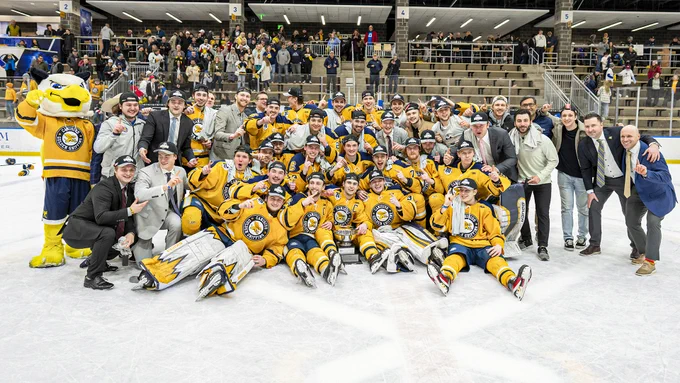 Members of the Canisius hockey team pose for a group photo after winning the 2023 Atlantic Hockey Championship Saturday at LECOM Harborcenter