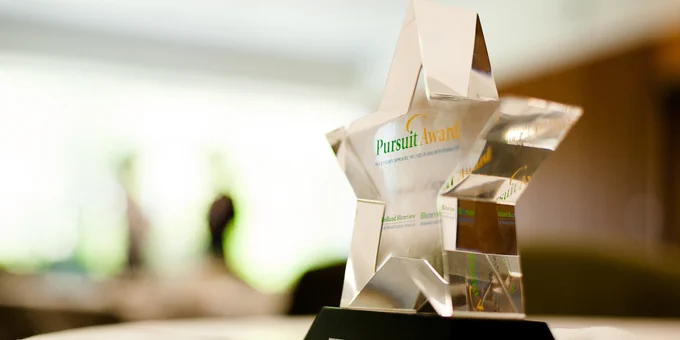 A close up of a Pursuit Awards International Competition trophy