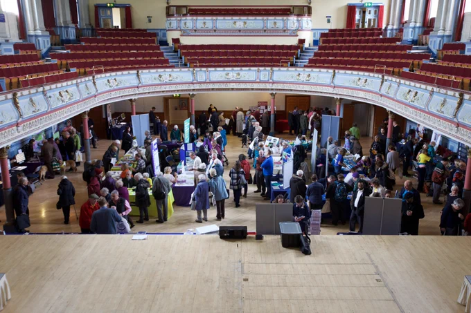 Vision Connect event people looking at stalls at huddersfield town hall