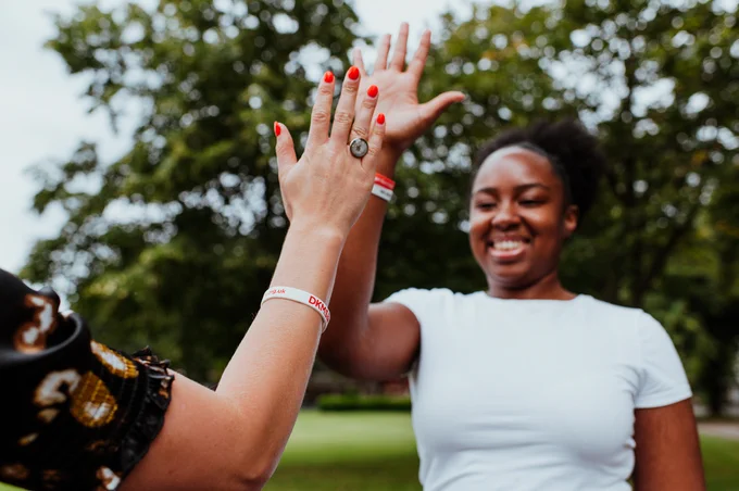 Woman smiling, giving high five 