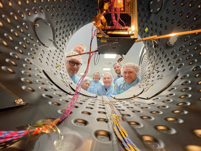 Photo: UCD research team photographhed in the lab beside Eirsat-1 satellite