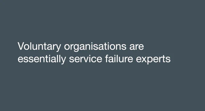 A screenshot of a slide that is white text on dark grey background. The text says "Voluntary organisations are essentially service failure experts".