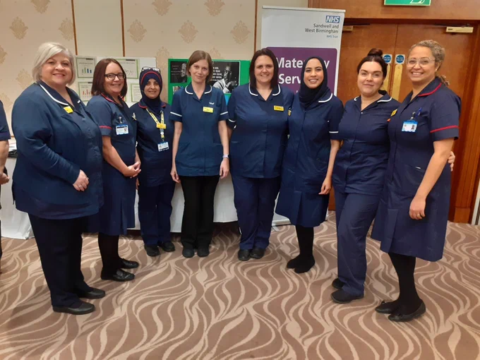 This photograph features midwives from the trust in a group at a previously held recruitment event. 