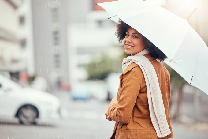 Woman holding an umbrella on a rainy day. 