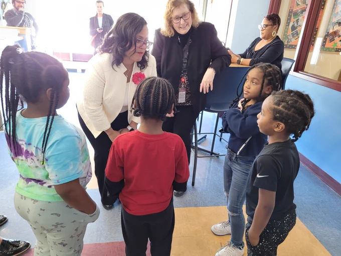 Minnesota Department of Education Deputy Commissioner Stephanie Burrage speaks to children while visiting Bethune Elementary School in Minneapolis. 