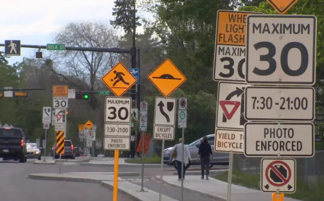 Highway littered with several dozen traffic signs