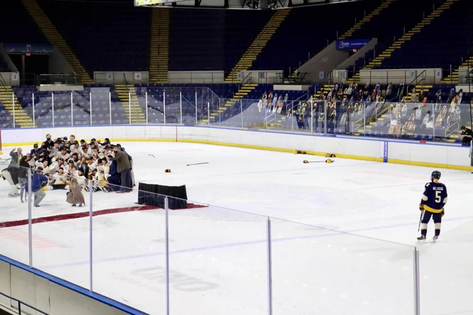 David Melaragni watches AIC celebrate the 2021 AHA Tournament Championship