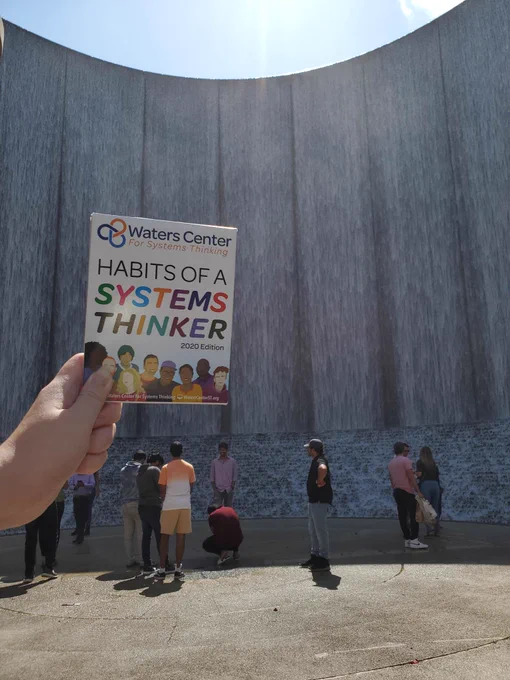 Waters Center Habits of a Systems Thinker card set in front of the Waterwall in Houston, TX