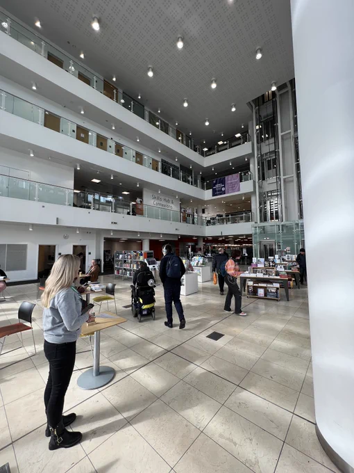 Photo showing entrance of Newcastle city library with people walking past